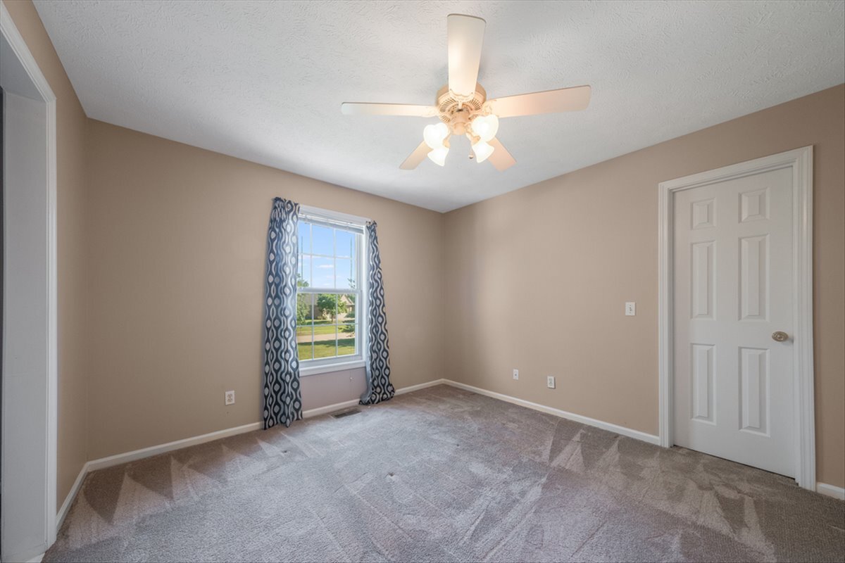 4406 Crossgate Drive Champaign, IL 61822 - Photo 42 of 64 an empty room with windows and fan