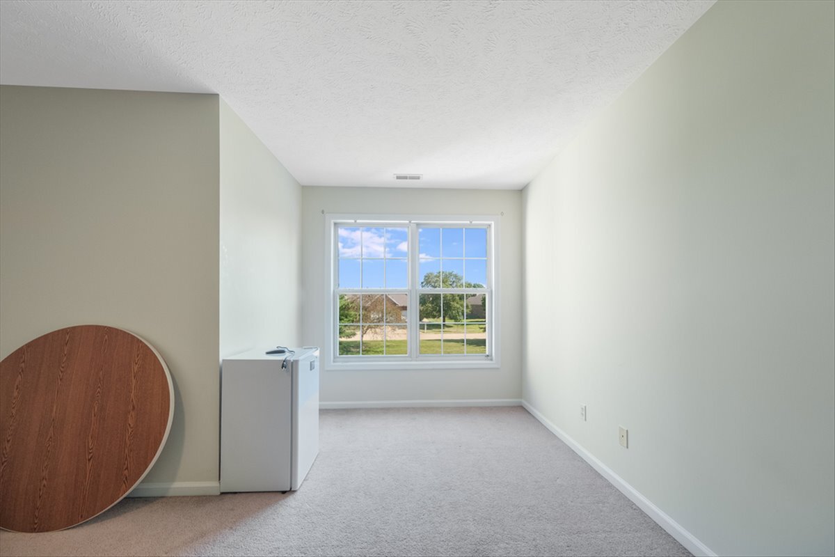 4406 Crossgate Drive Champaign, IL 61822 - Photo 49 of 64 an empty room with windows
