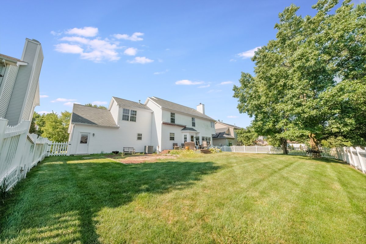 4406 Crossgate Drive Champaign, IL 61822 - Photo 57 of 64 a big yard with table and chairs in front of the house