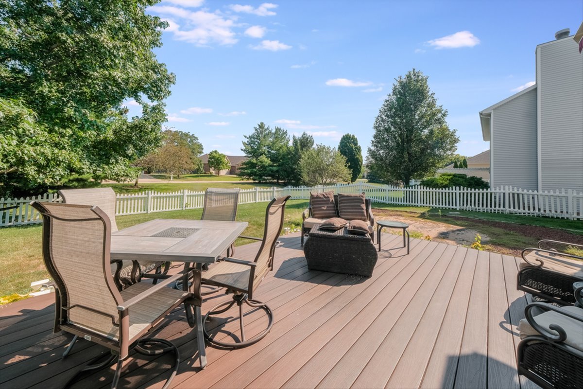 4406 Crossgate Drive Champaign, IL 61822 - Photo 58 of 64 a view of a roof deck with table and chairs with wooden floor and fence