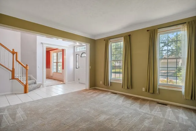 a view of an empty room with a fireplace and cabinet