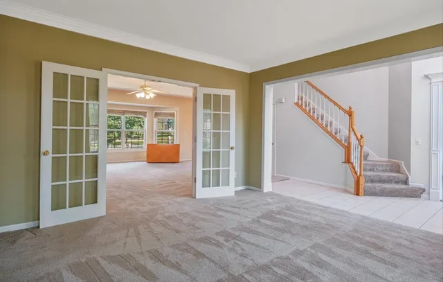a view of an empty room with a fireplace and a window