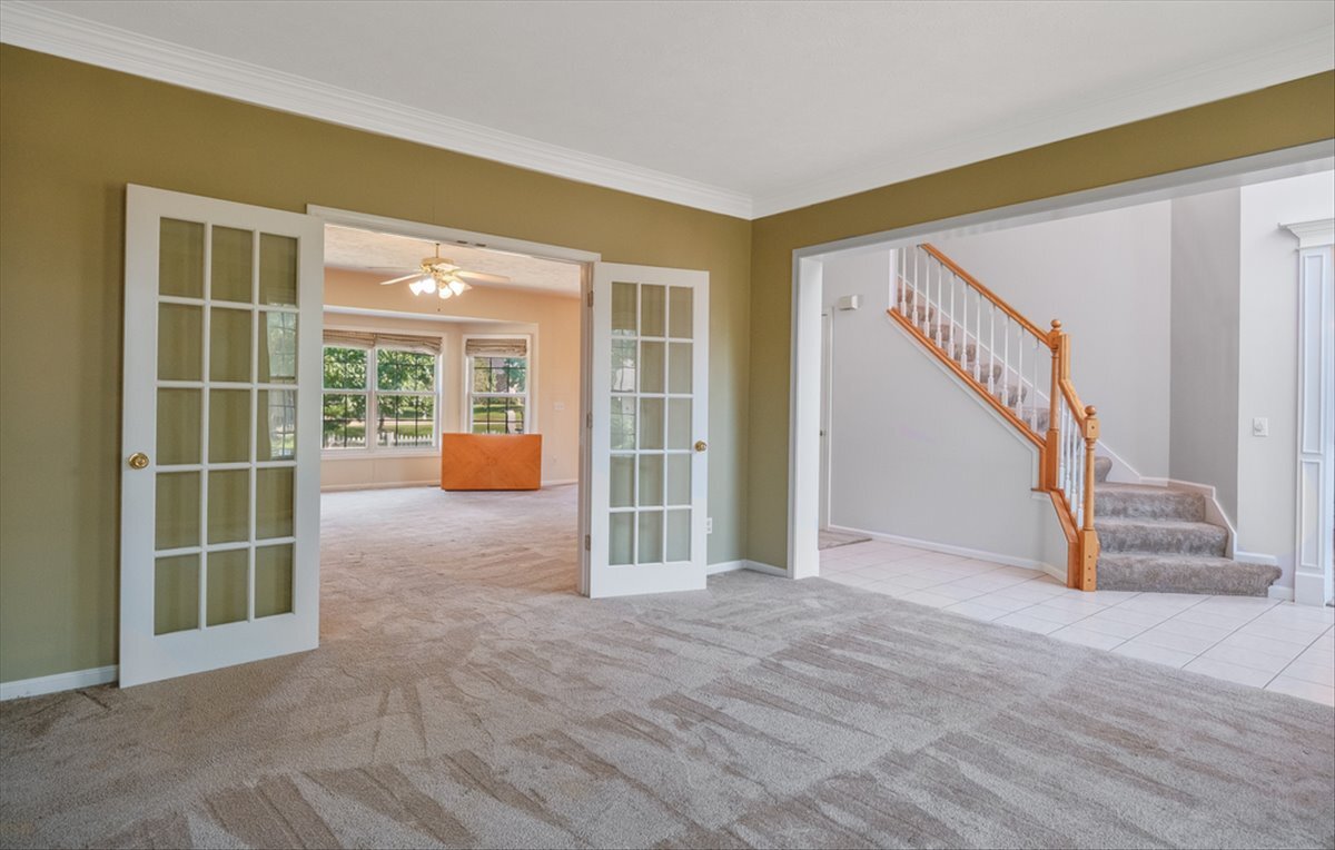 4406 Crossgate Drive Champaign, IL 61822 - Photo 9 of 64 a view of an empty room with stairs and toys