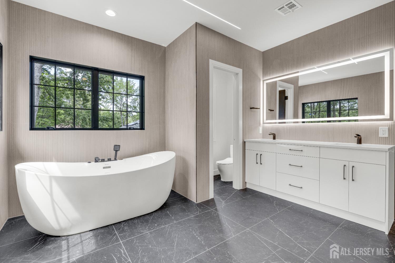 28 Harding Avenue Edison, NJ 08820 - Photo 27 of 62 a spacious bathroom with a double vanity sink a mirror and a bathtub