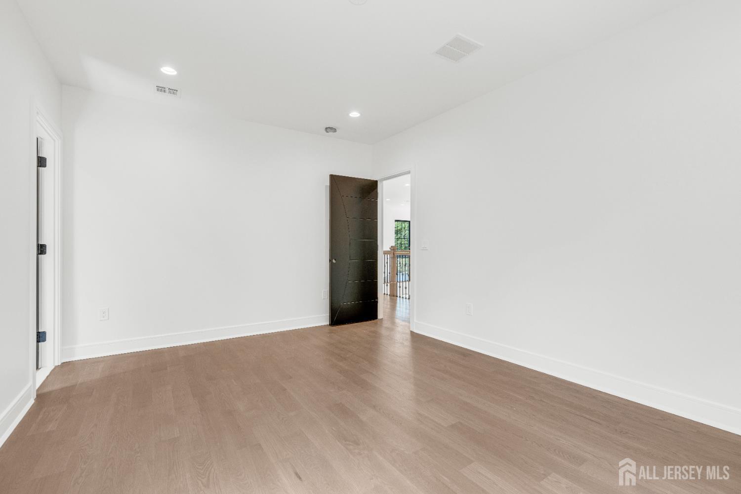 28 Harding Avenue Edison, NJ 08820 - Photo 31 of 62 a view of an empty room with wooden floor