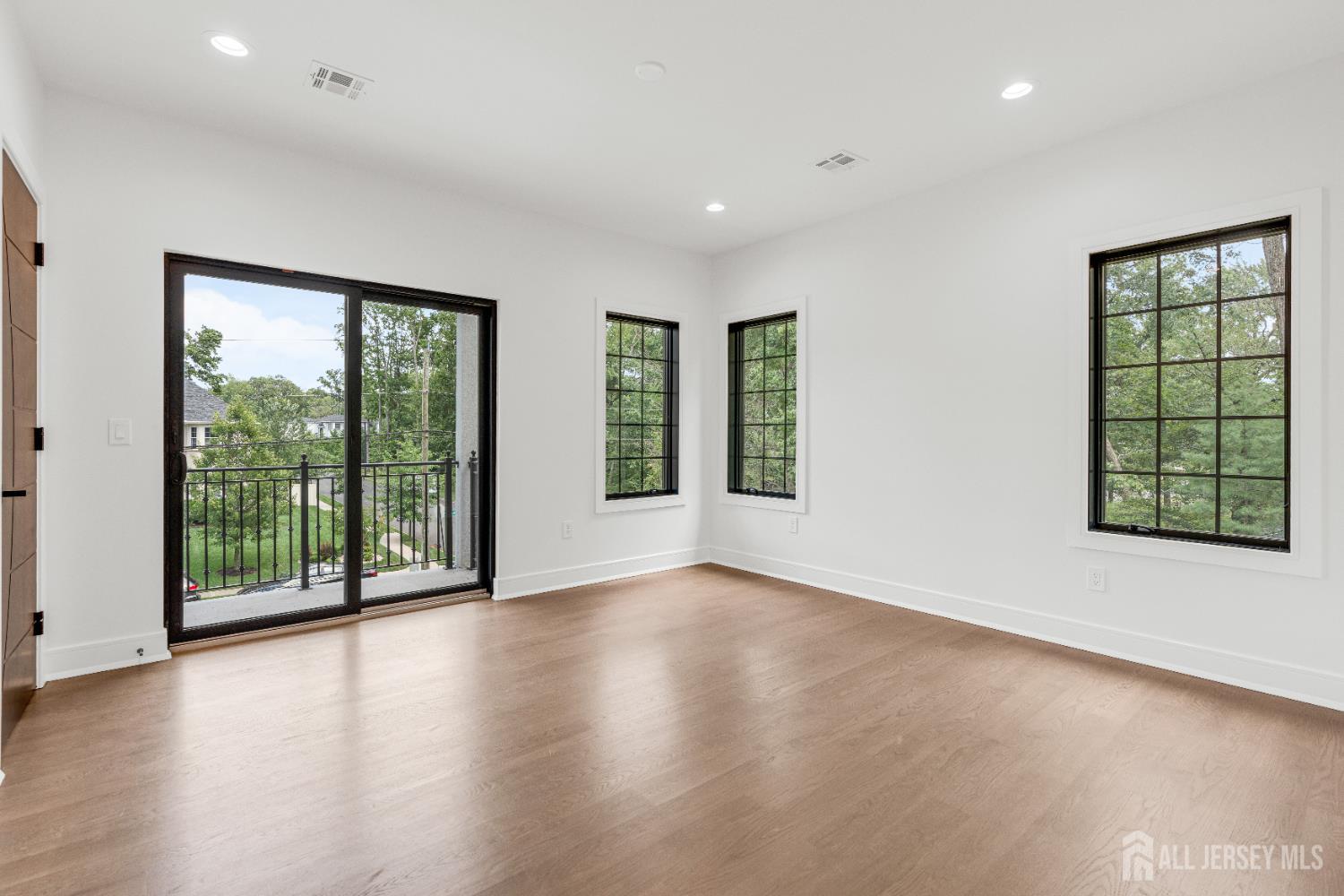 28 Harding Avenue Edison, NJ 08820 - Photo 33 of 62 a view of an empty room with wooden floor and a window
