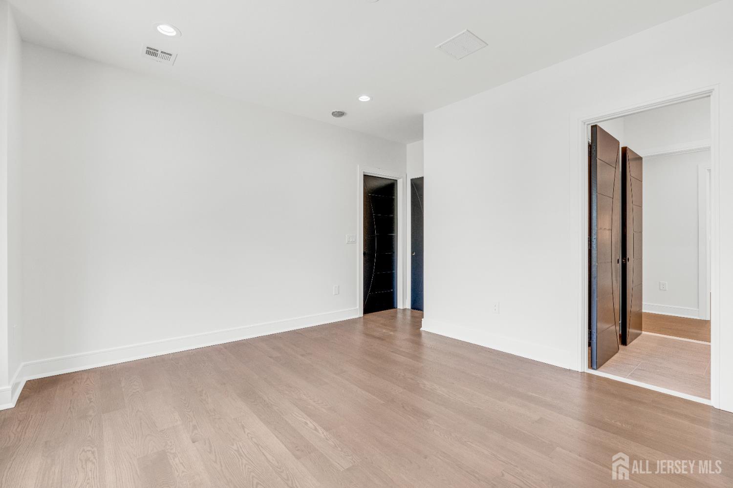 28 Harding Avenue Edison, NJ 08820 - Photo 37 of 62 a view of an empty room with wooden floor