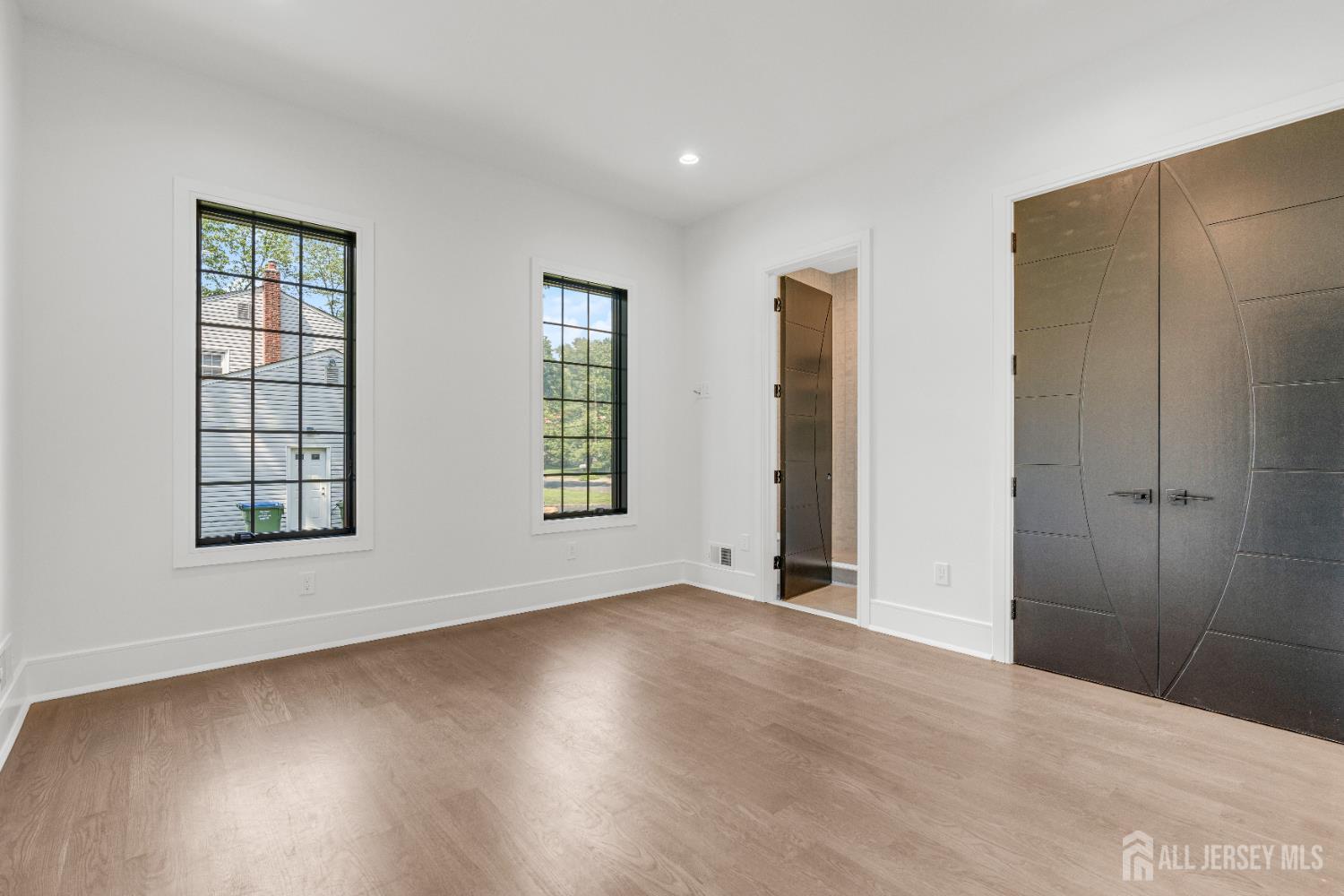 28 Harding Avenue Edison, NJ 08820 - Photo 42 of 62 an empty room with wooden floor and windows