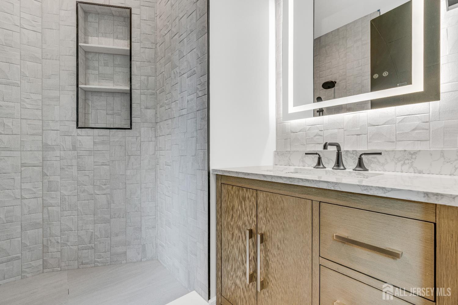 28 Harding Avenue Edison, NJ 08820 - Photo 44 of 62 a bathroom with a sink and a mirror