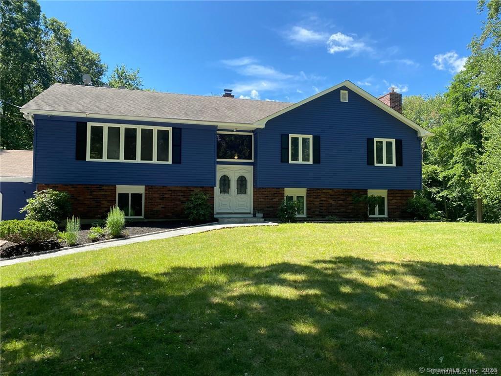 34 Lloyd Street Hamden, CT 06518 - Photo 3 of 7 a front view of a house with a yard