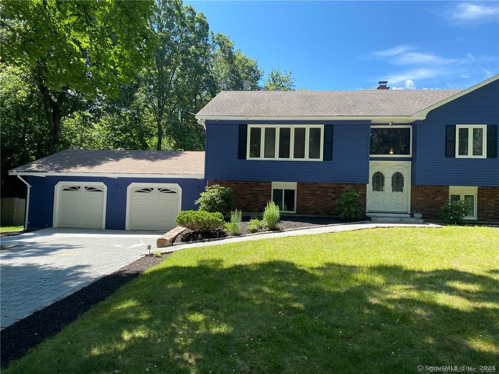 34 Lloyd Street Hamden, CT 06518 - Photo 4 of 7 a front view of a house with a yard and garage