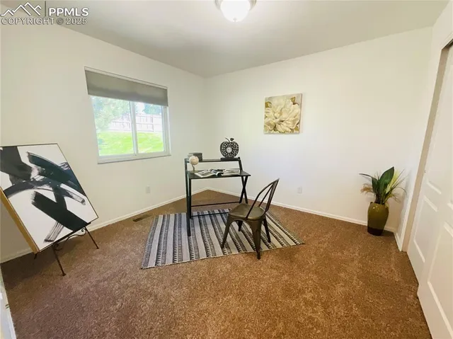 a view of a room with furniture and a window