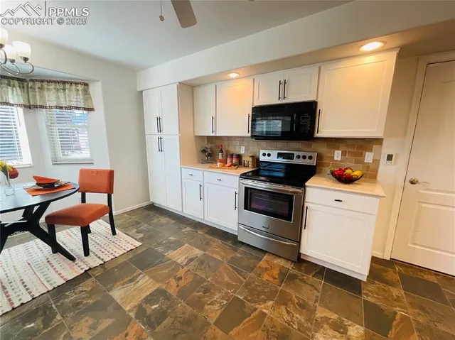 a kitchen with stainless steel appliances a stove a sink and a refrigerator