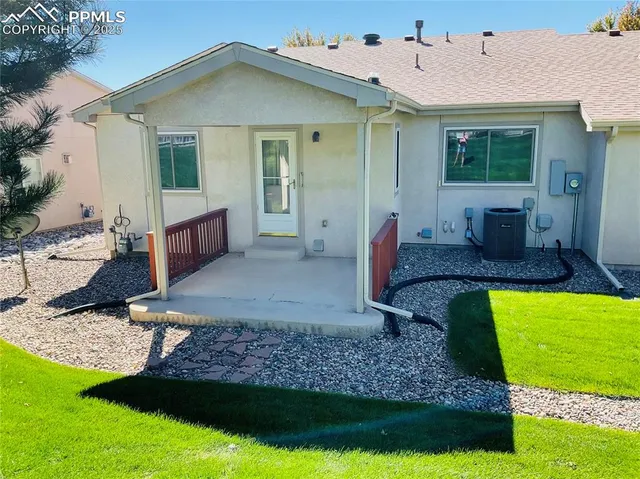 a view of an house with backyard space and balcony