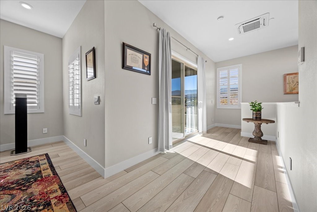 4262 Swift Street Las Vegas, NV 89135 - Photo 46 of 75 Hallway with light wood-style floors, recessed lighting, and cooling unit