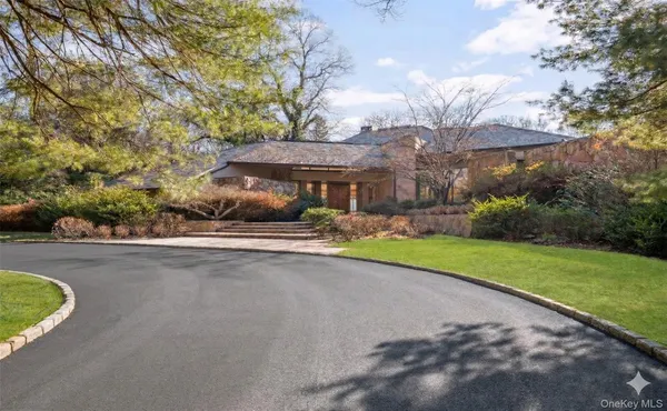 a view of a house with a swimming pool and a yard