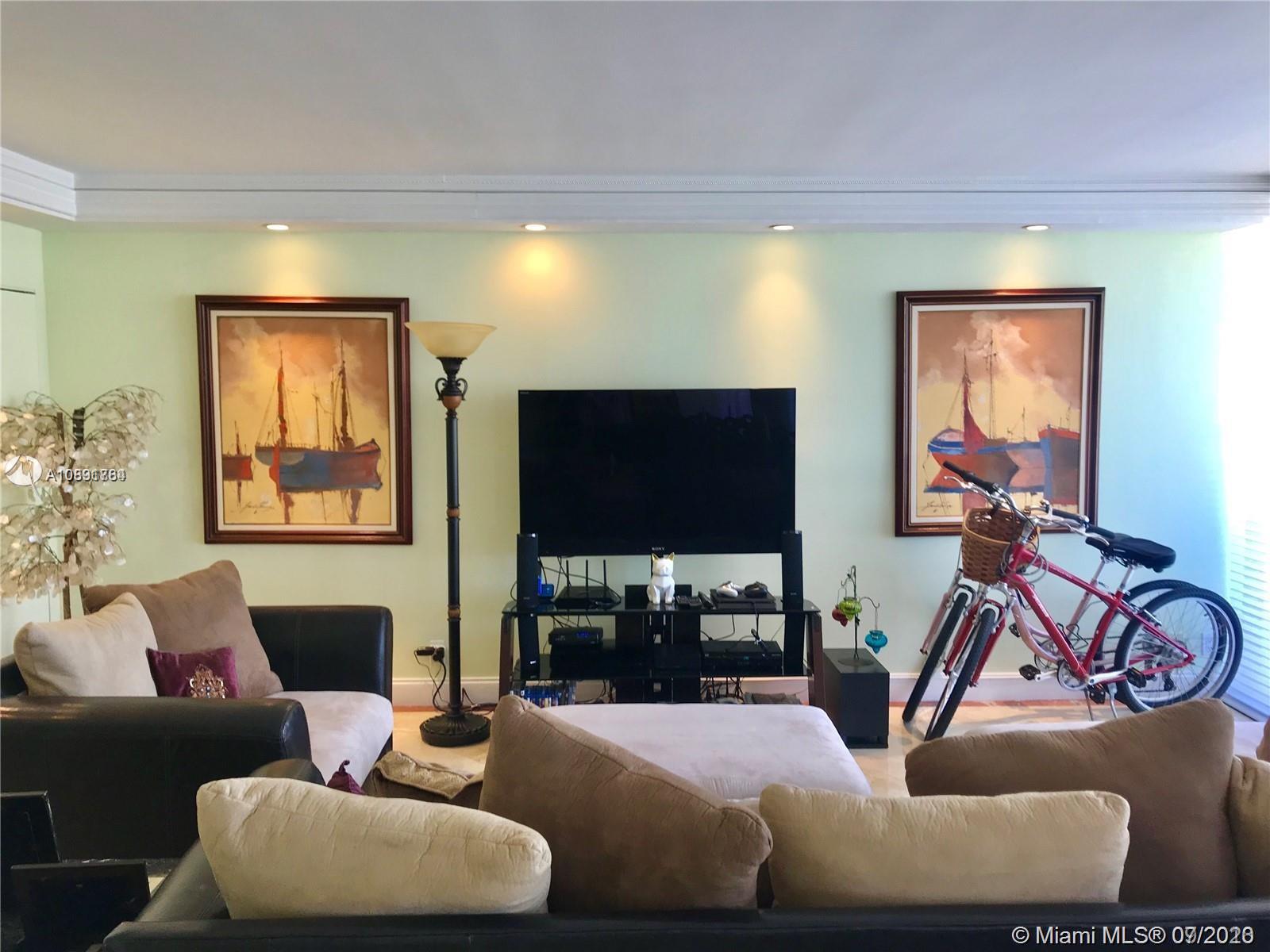 Williams Island Aventura, FL 33160 - Photo 2 of 23 a living room with furniture and a flat screen tv