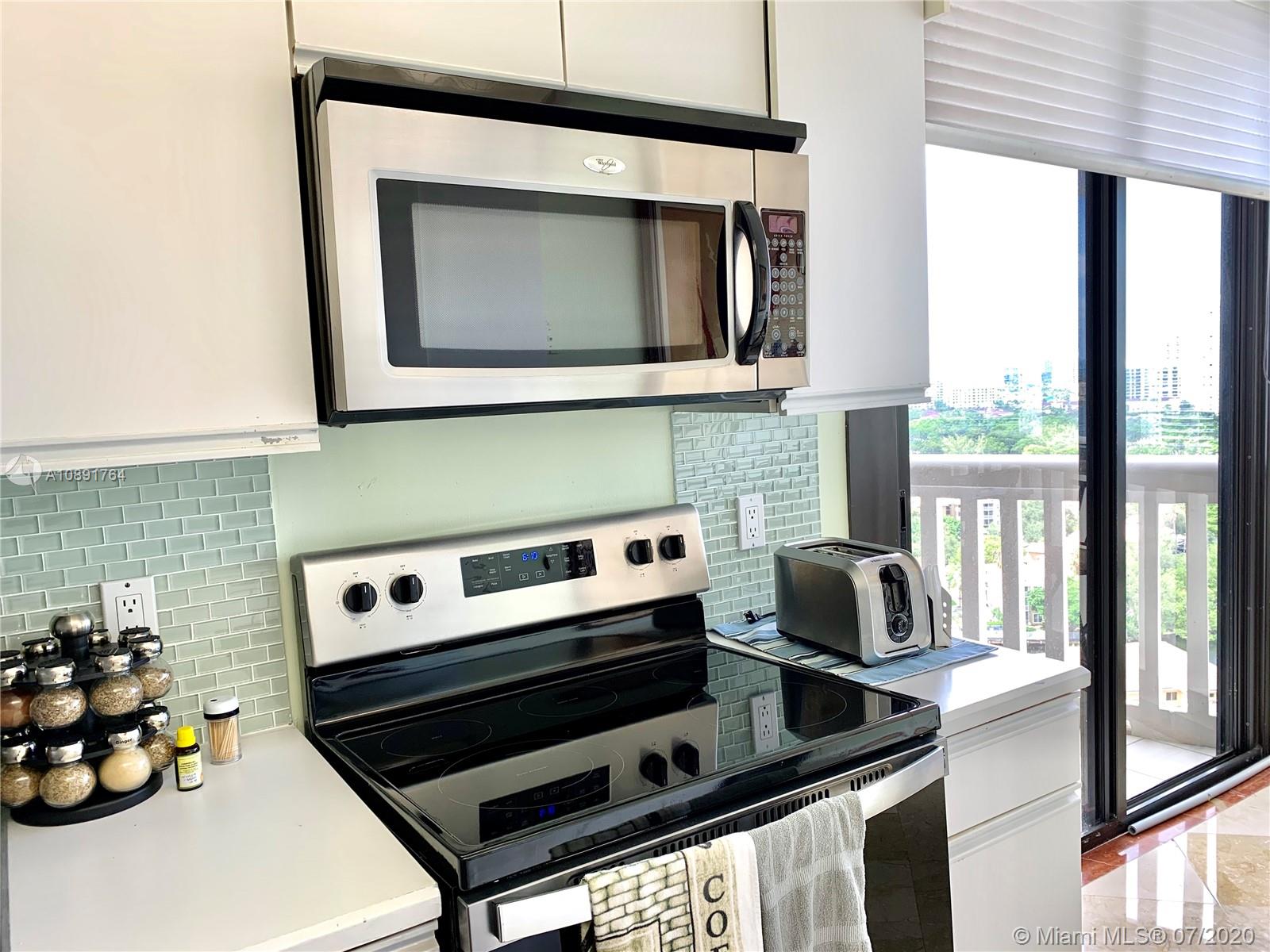 Williams Island Aventura, FL 33160 - Photo 13 of 23 a kitchen with a stove and a microwave