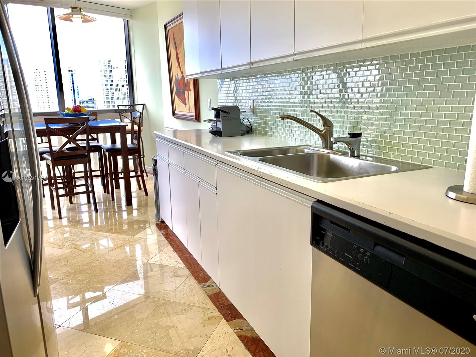 Williams Island Aventura, FL 33160 - Photo 14 of 23 a kitchen with a sink a stove and a microwave