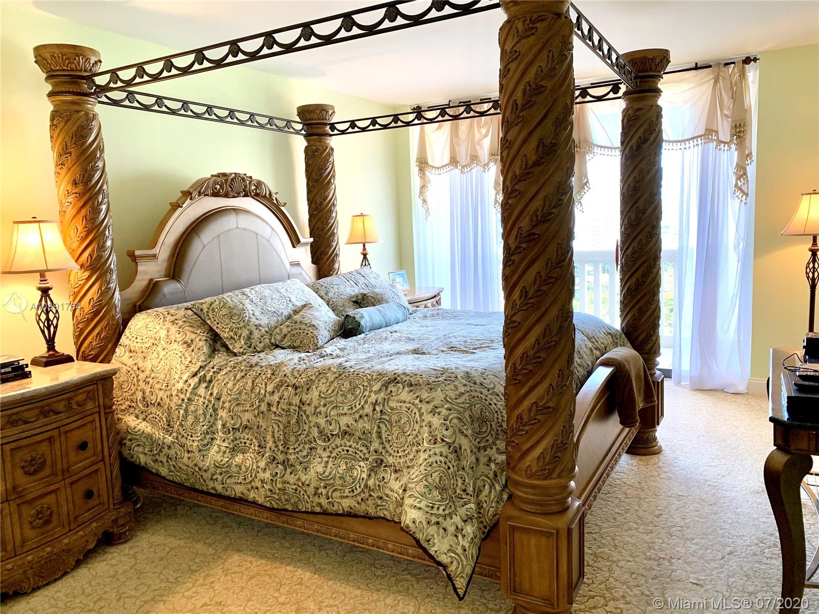 Williams Island Aventura, FL 33160 - Photo 16 of 23 a bedroom with a bed and a dresser