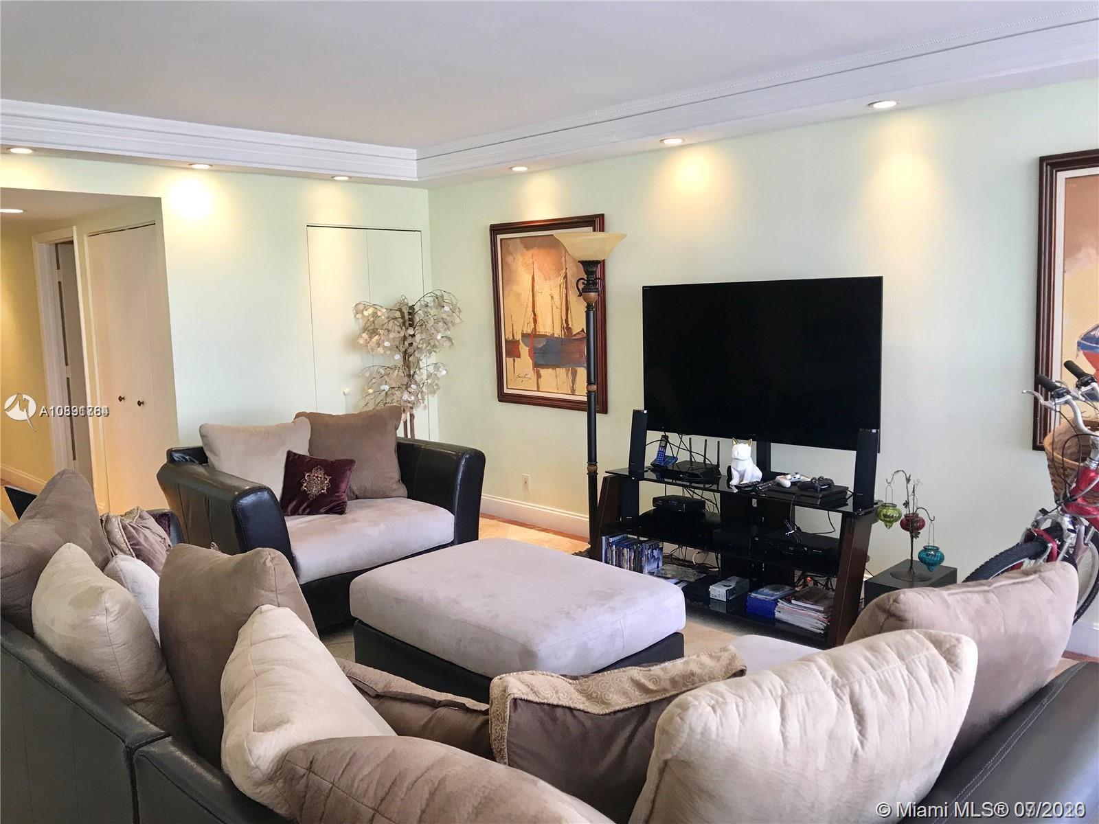 Williams Island Aventura, FL 33160 - Photo 3 of 23 a living room with furniture and a flat screen tv