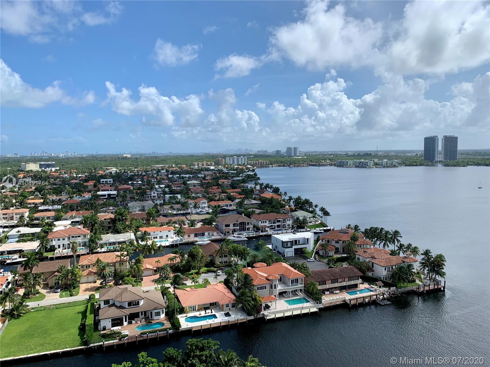 Williams Island Aventura, FL 33160 - Photo 21 of 23 an aerial view of a city with lots of residential buildings ocean and mountain view in back