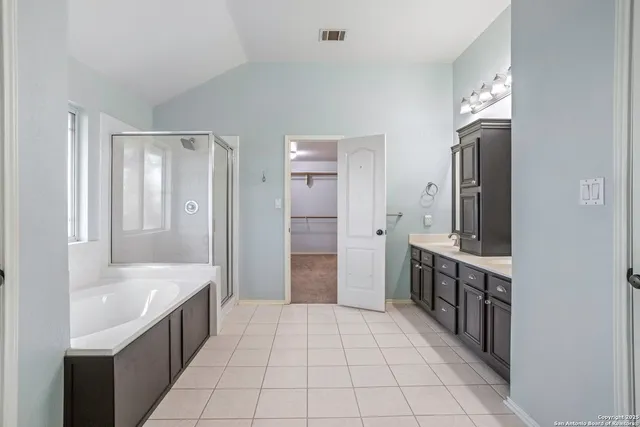 a bathroom with a sink a mirror and a bathtub