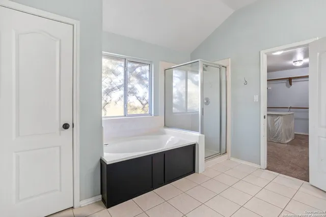 a spacious bathroom with a shower and a sink