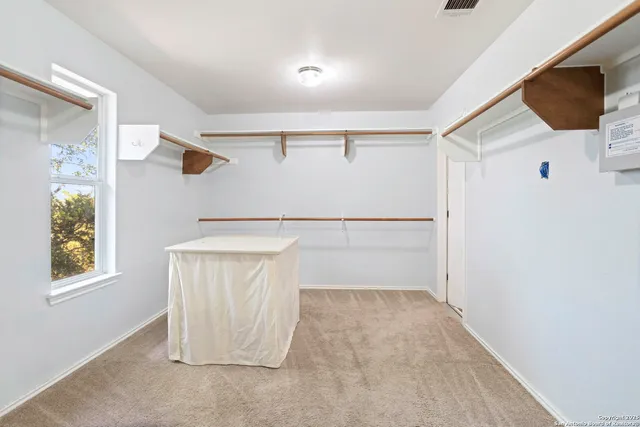 a view of walk in closet with window