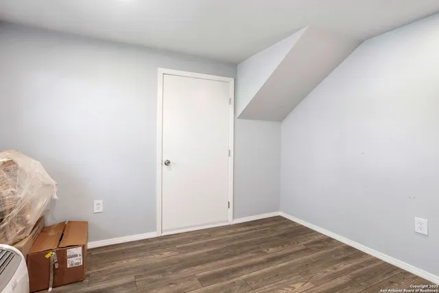 a view of room with wooden floor and chair