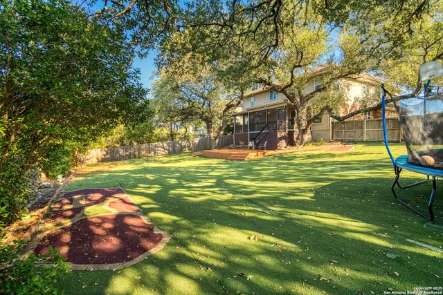 a backyard of a house with table and chairs