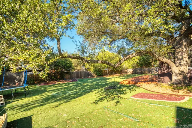 a view of yard with swimming pool