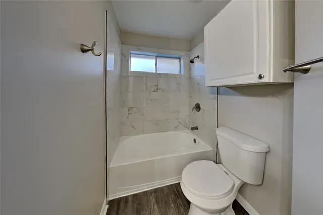 a front view of a house with a garden and yard