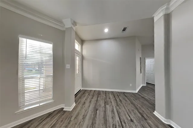 a view of kitchen and a fireplace with wooden floor