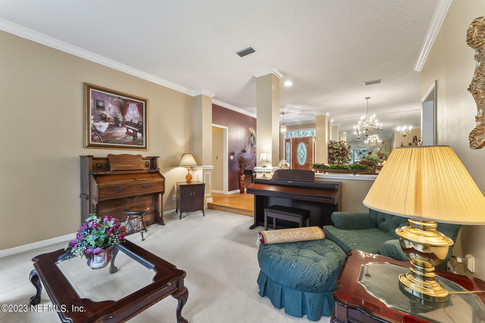 42 Harmony Hall Road Middleburg, FL 32068 - Photo 12 of 70 a living room with furniture and a chandelier