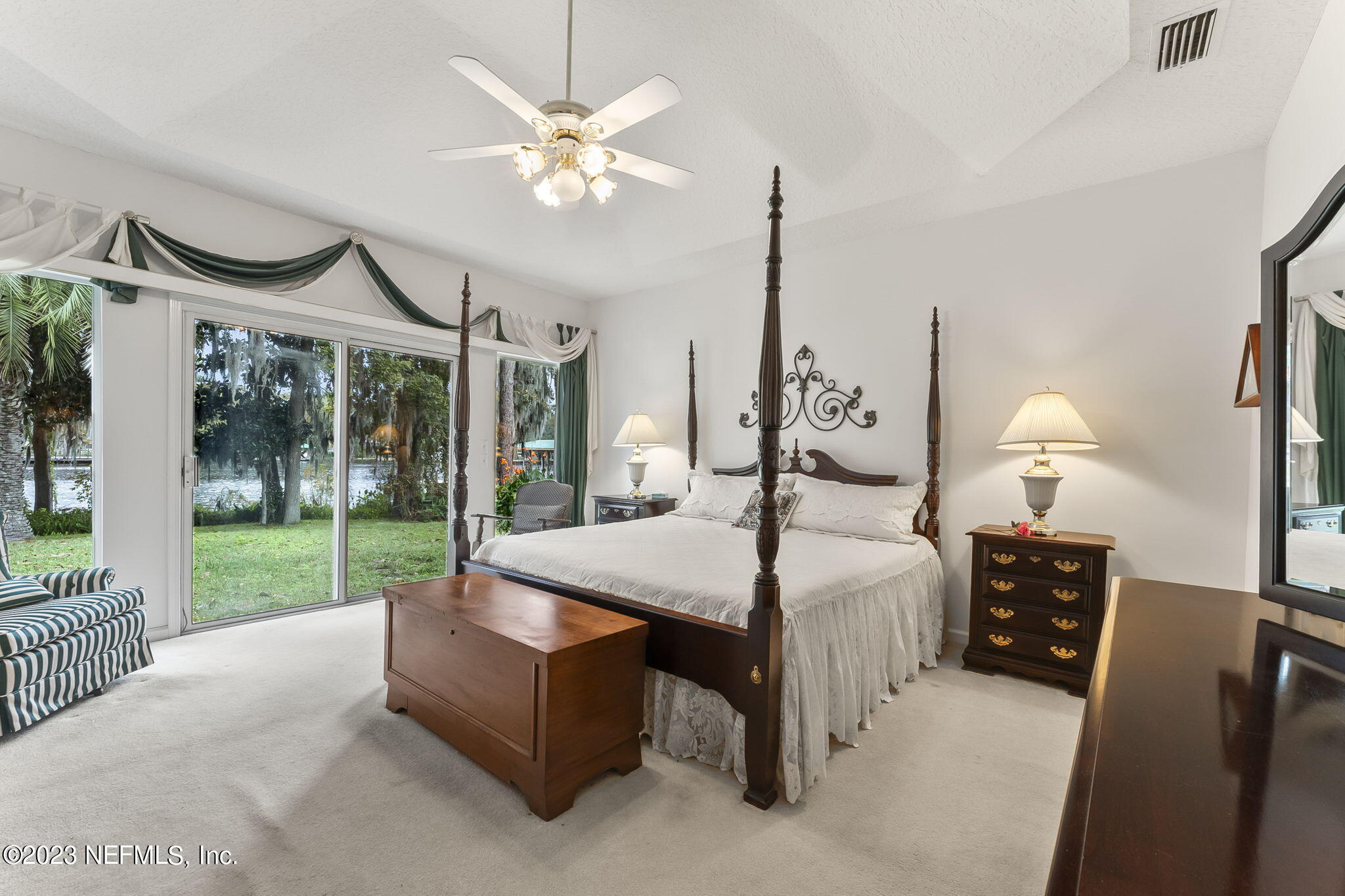 42 Harmony Hall Road Middleburg, FL 32068 - Photo 25 of 70 a bed room with a bed window and a mirror