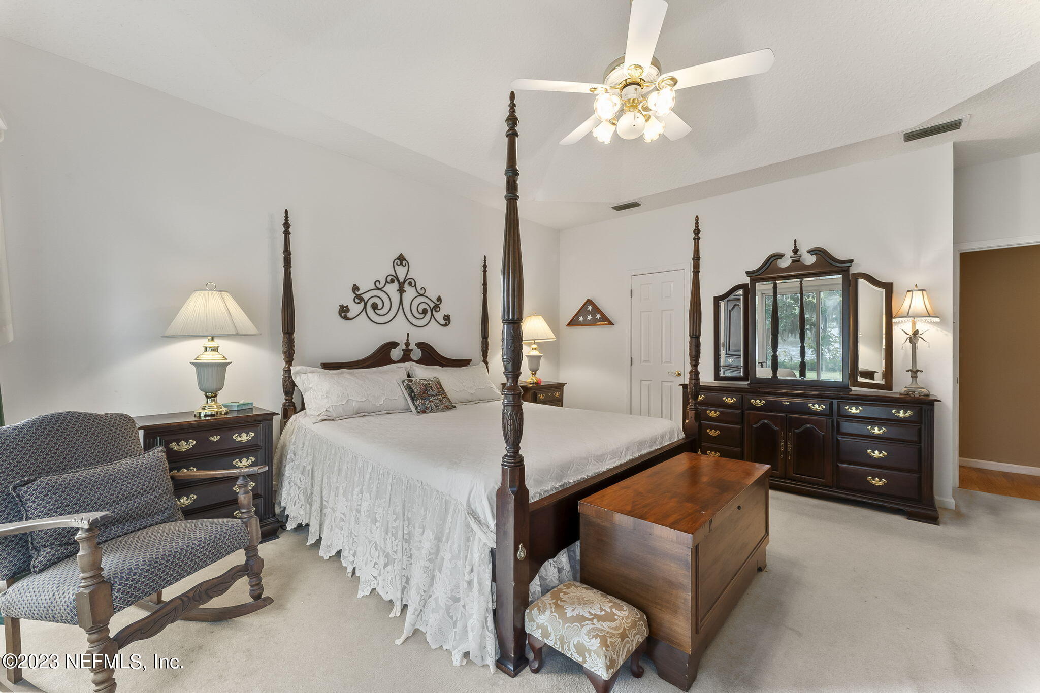 42 Harmony Hall Road Middleburg, FL 32068 - Photo 26 of 70 a bedroom with bed and a chandelier