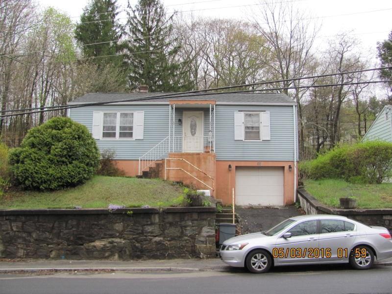 59 Bucks Hill Road Waterbury, CT 06704 - Photo 1 of 1 a car parked in front of a white house
