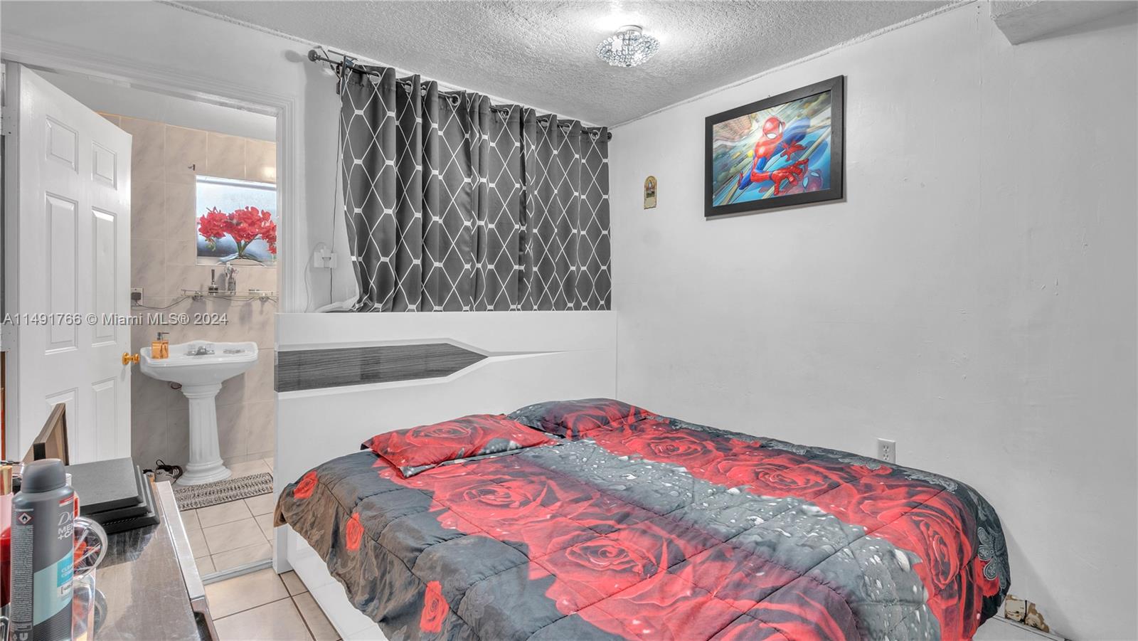 770 Southeast 4th Place Hialeah, FL 33010 - Photo 11 of 19 a bedroom with a bed and a painting on the wall