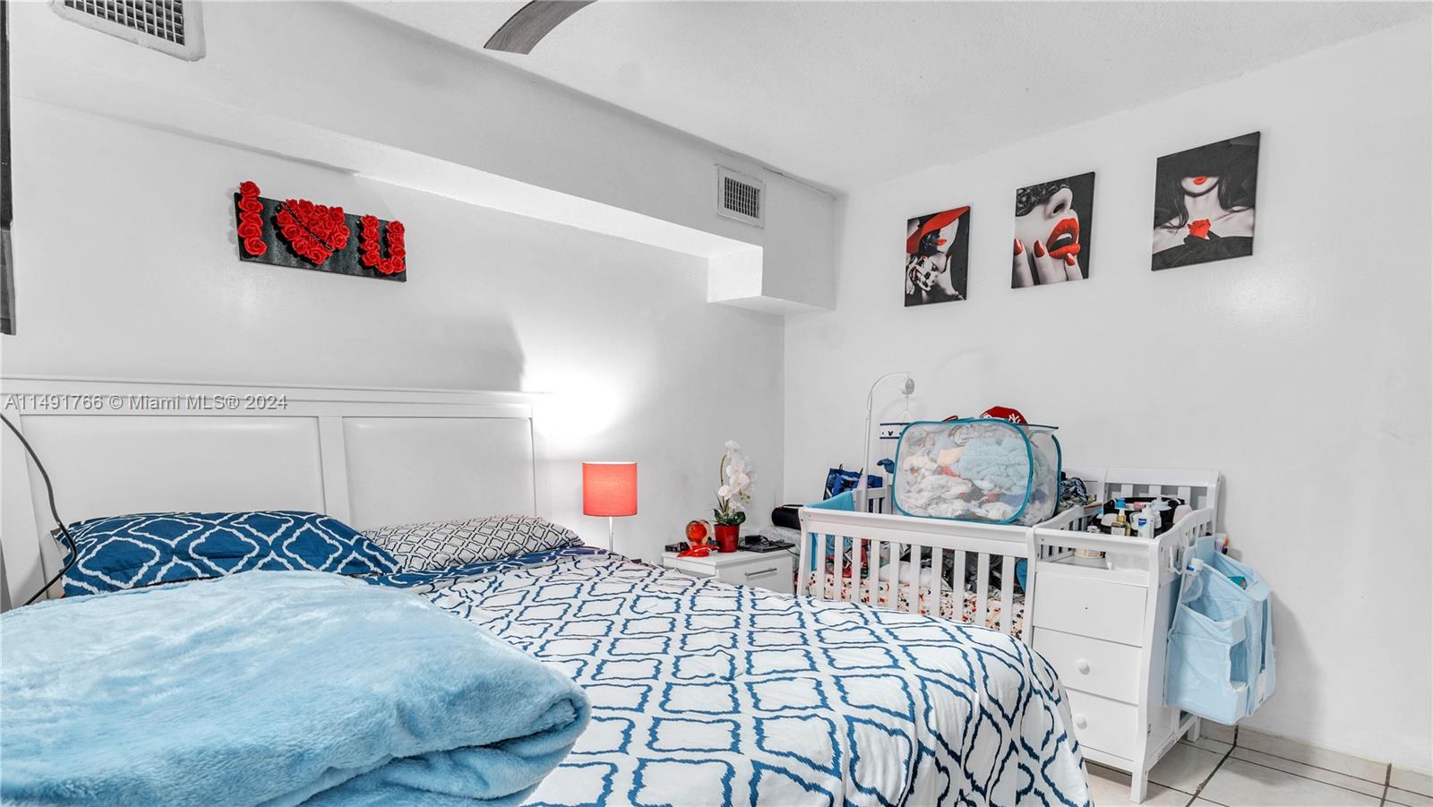 770 Southeast 4th Place Hialeah, FL 33010 - Photo 12 of 19 a bedroom with a bed and cabinets