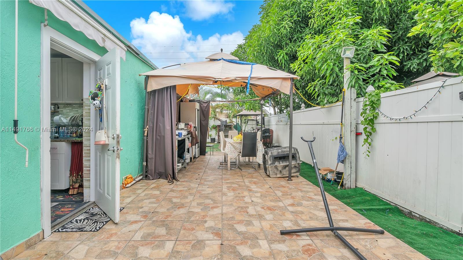 770 Southeast 4th Place Hialeah, FL 33010 - Photo 13 of 19 a view of a patio with table and chairs under an umbrella