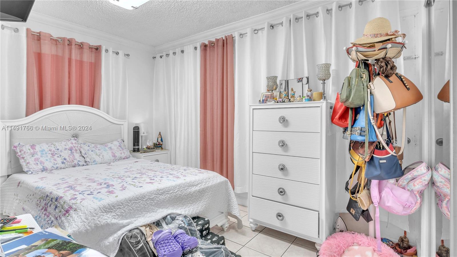 770 Southeast 4th Place Hialeah, FL 33010 - Photo 17 of 19 a bedroom with a bed and a window