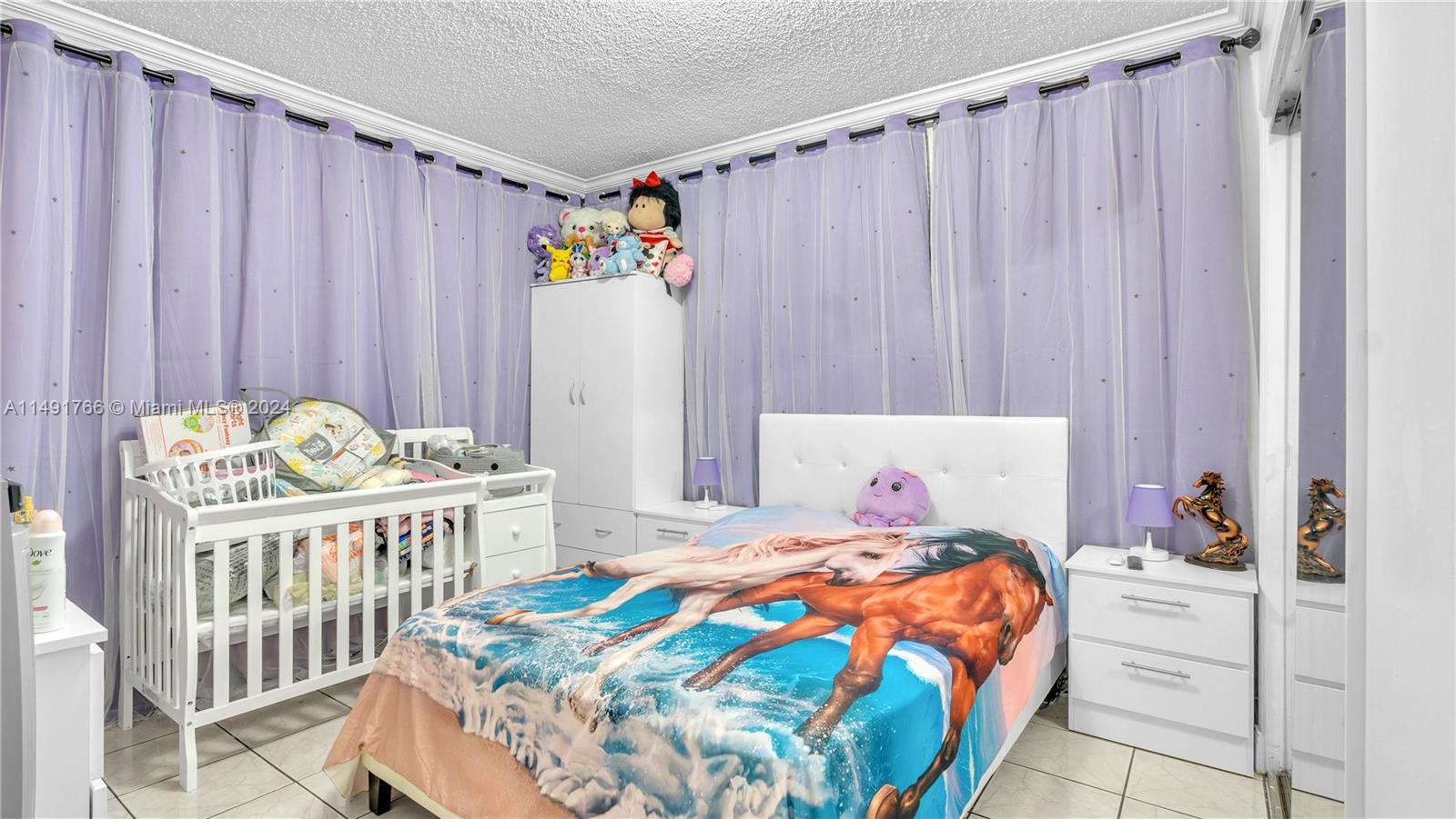 770 Southeast 4th Place Hialeah, FL 33010 - Photo 18 of 19 a bedroom with a bed and a table