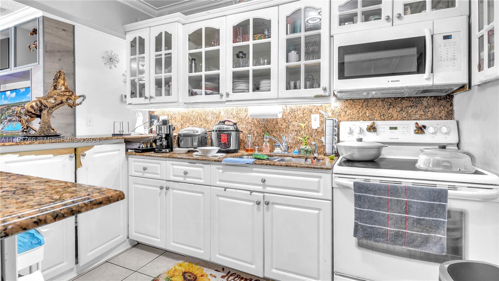 770 Southeast 4th Place Hialeah, FL 33010 - Photo 5 of 19 a kitchen with stainless steel appliances granite countertop a stove and a sink