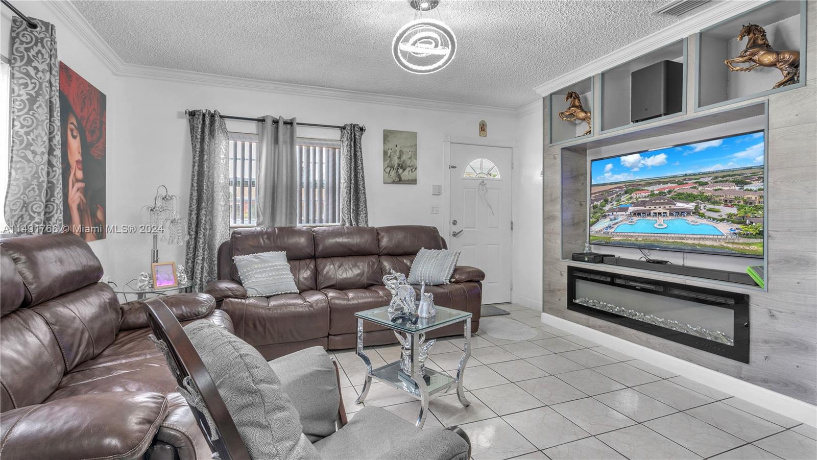 770 Southeast 4th Place Hialeah, FL 33010 - Photo 7 of 19 a living room with furniture and a flat screen tv
