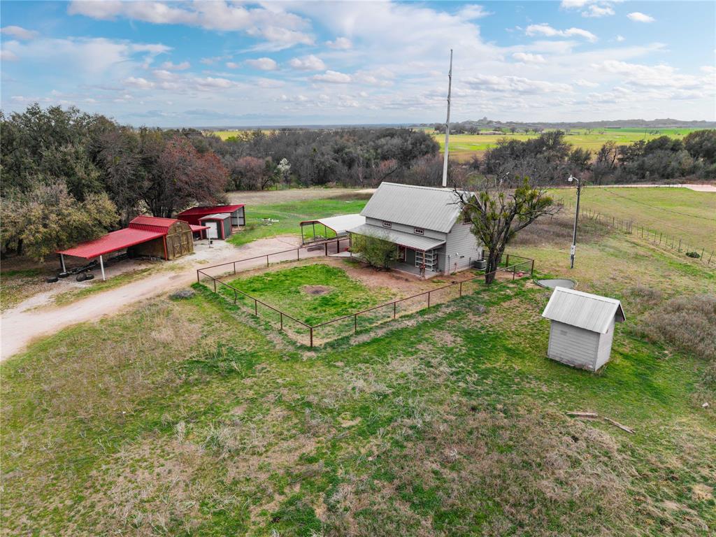 Cozy home with 9.4 acres, animal pens, storage, covered parking, lots of trees and a water well that services the property