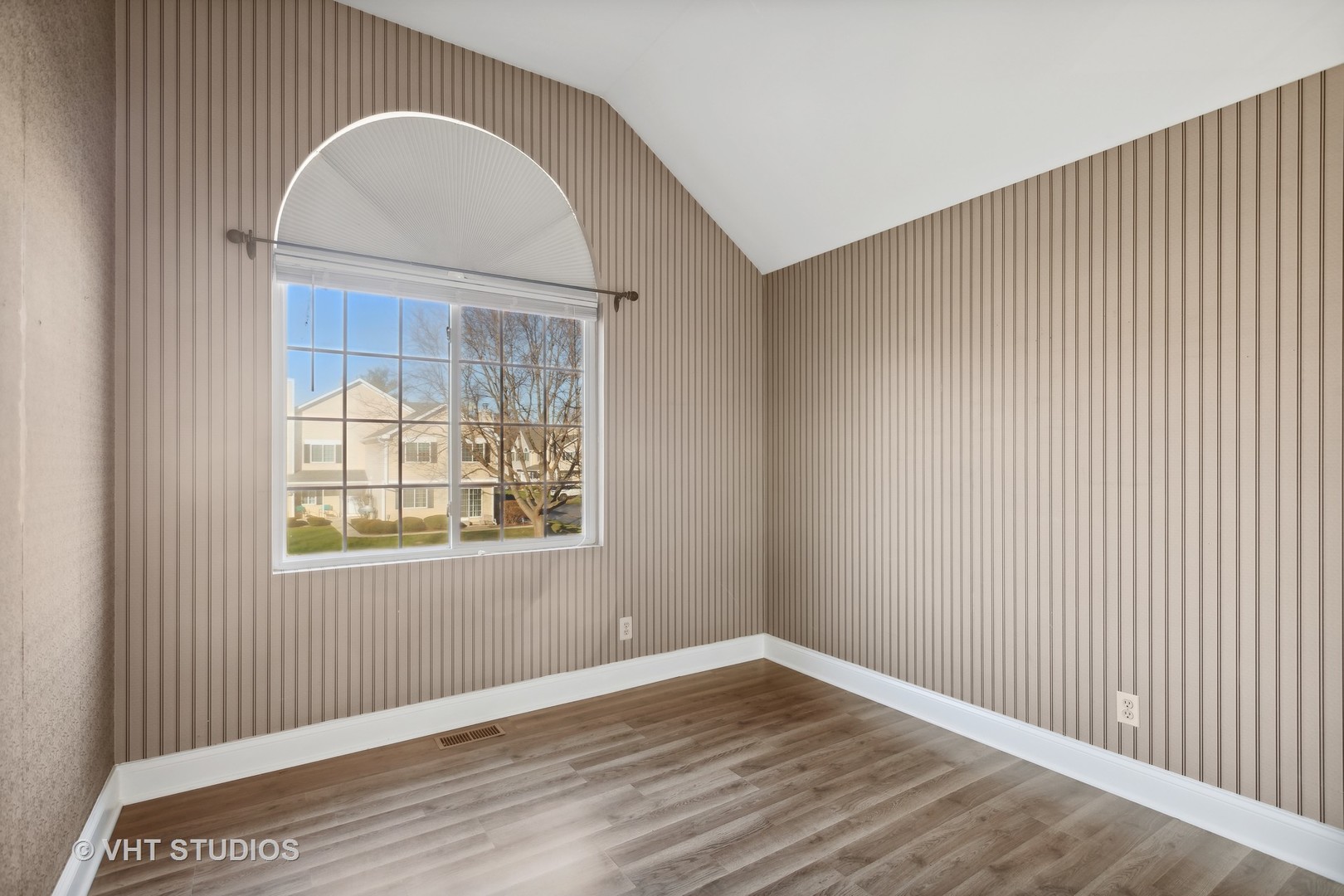 618 Silver Creek Road, Unit 618 Woodstock, IL 60098 - Photo 11 of 21 a view of an empty room with wooden floor and a window