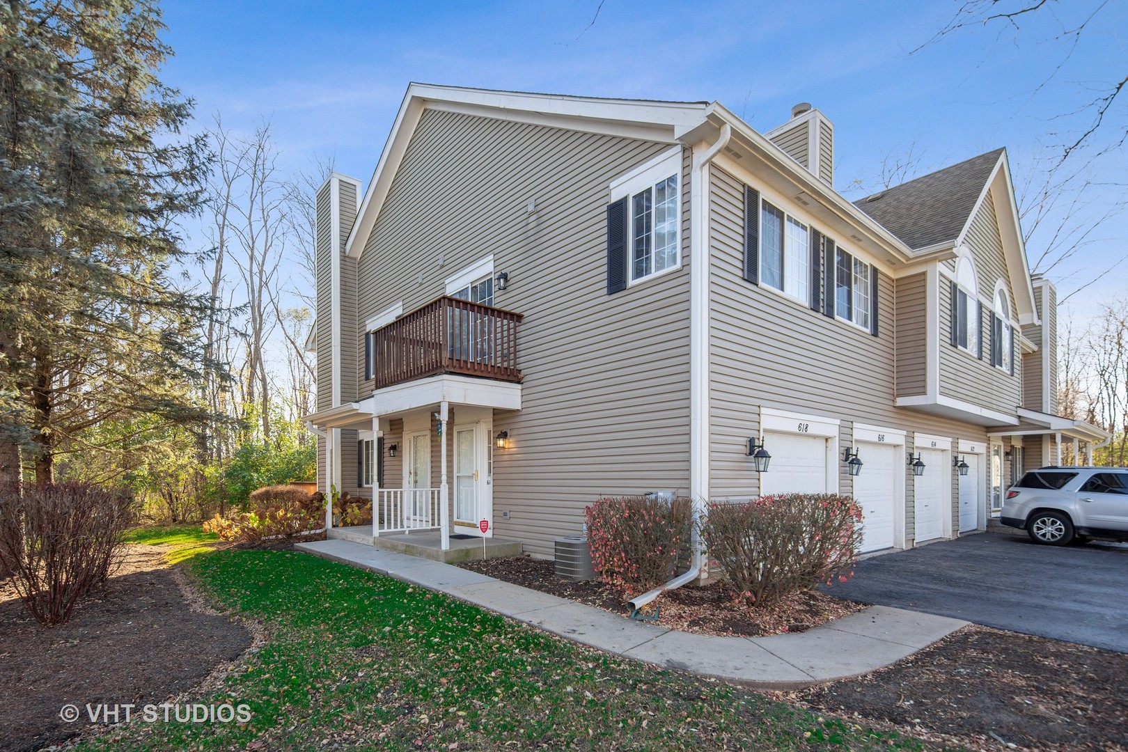 618 Silver Creek Road, Unit 618 Woodstock, IL 60098 - Photo 2 of 21 a front view of a house with a yard and table and chairs