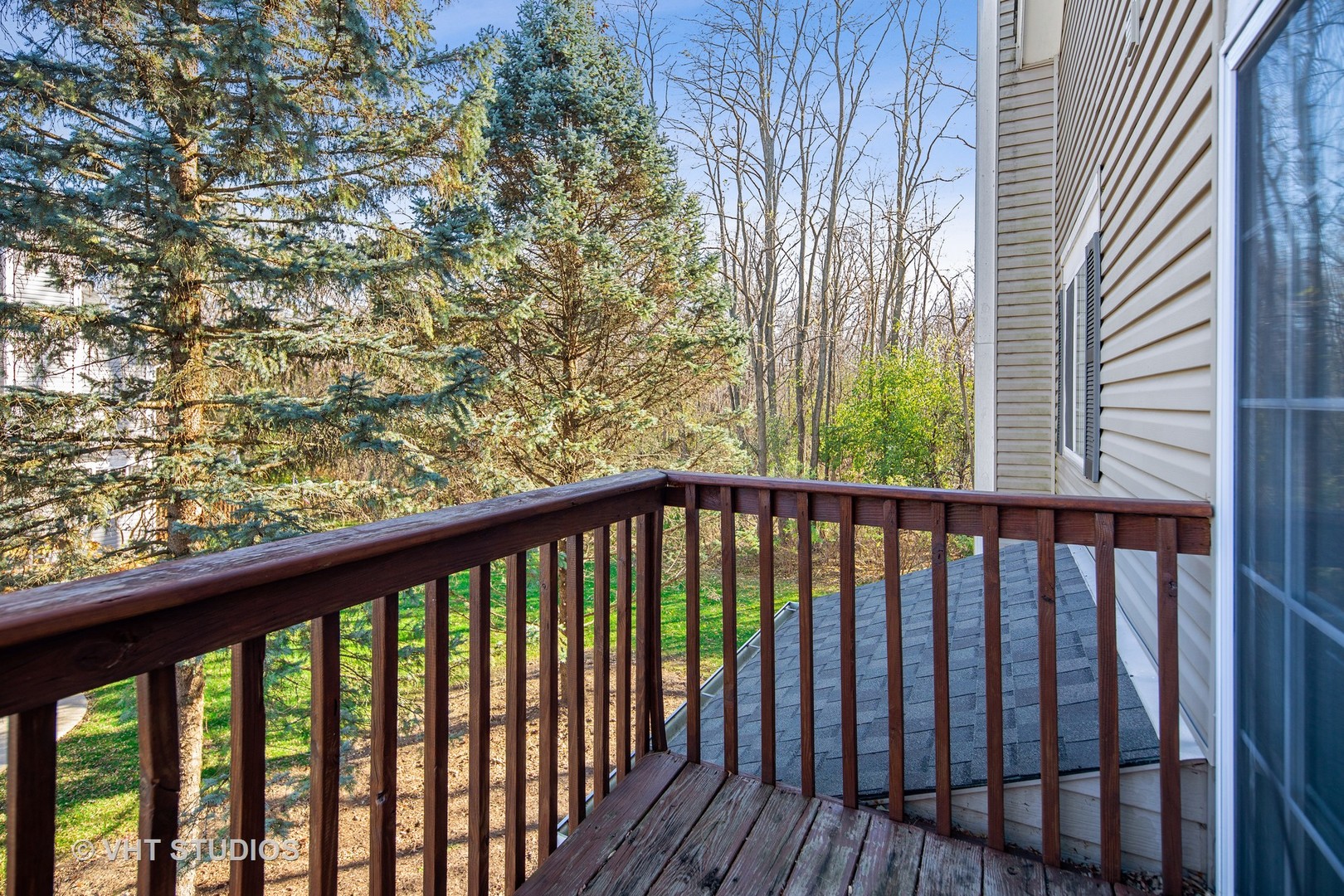 618 Silver Creek Road, Unit 618 Woodstock, IL 60098 - Photo 4 of 21 a view of a balcony with wooden floor