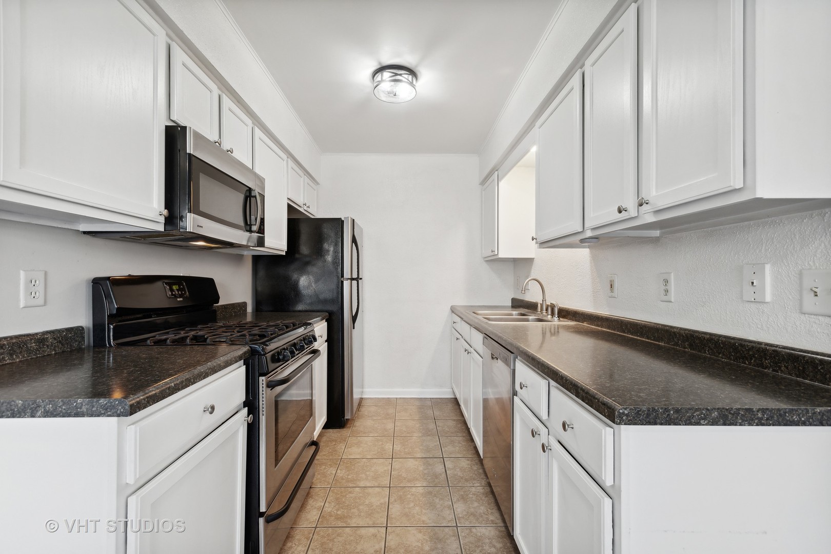 618 Silver Creek Road, Unit 618 Woodstock, IL 60098 - Photo 6 of 21 a kitchen with granite countertop a sink and steel appliances